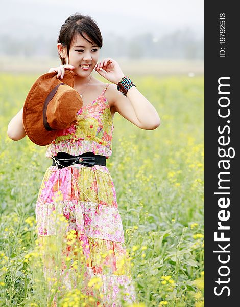 Beautiful Asian girl standing in field. Beautiful Asian girl standing in field.