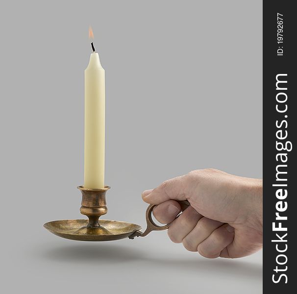 Old Candlestick with flame lights and hand (clipping path). Old Candlestick with flame lights and hand (clipping path)