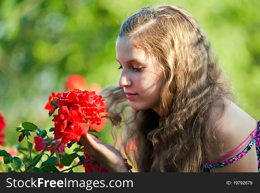 Portrait of a young girl in the garden of blooming roses. Portrait of a young girl in the garden of blooming roses.