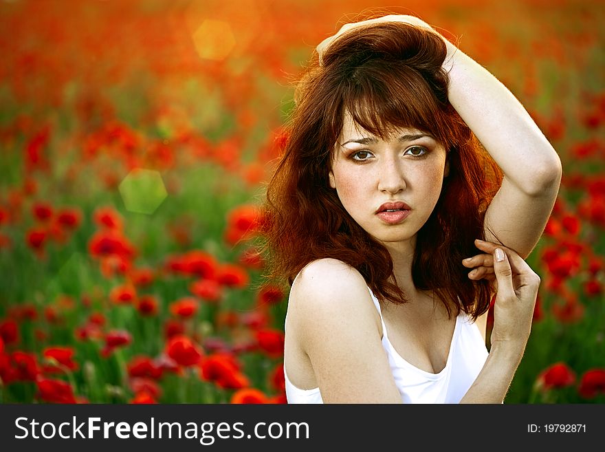 Woman Closeup Portrait In Poppy Field