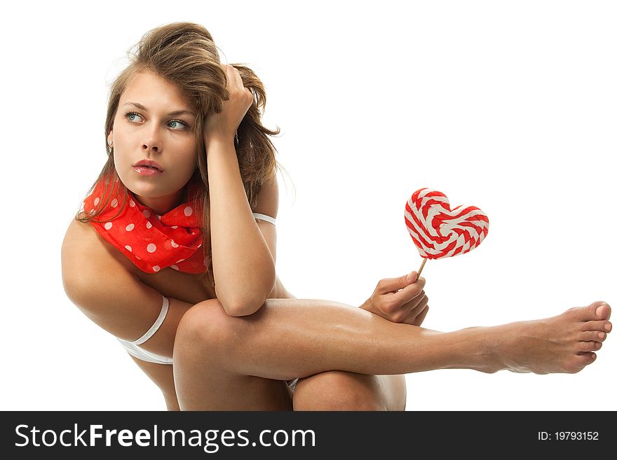 Close-up portrait of young woman sitting with heart shaped lollipop. Close-up portrait of young woman sitting with heart shaped lollipop