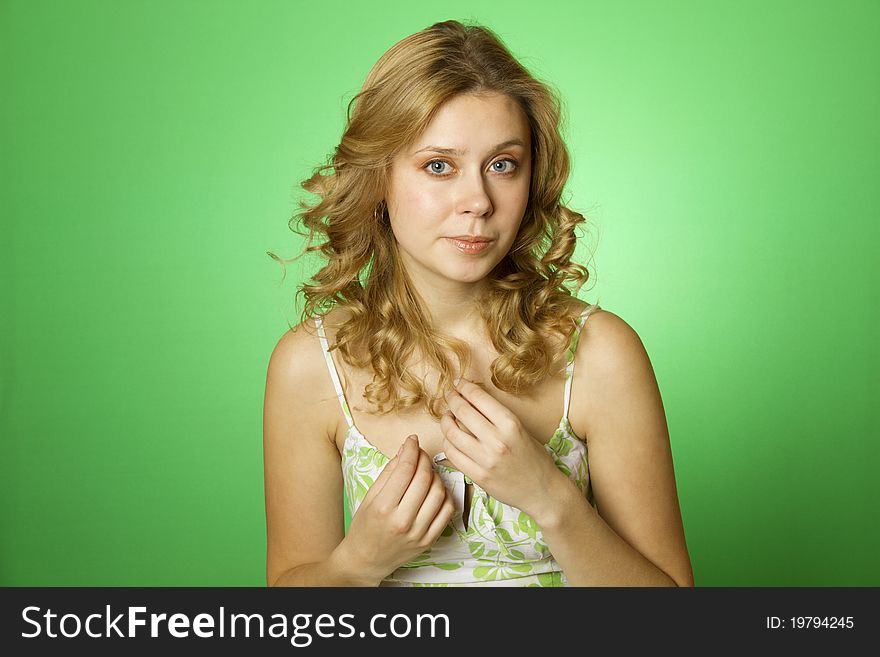 Closeup of an attractive young woman in a dress with a green background. Closeup of an attractive young woman in a dress with a green background
