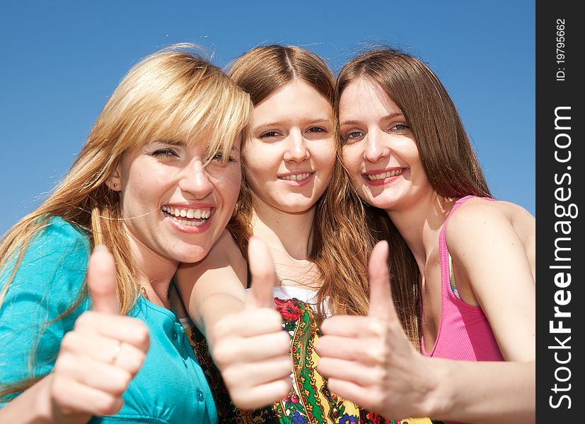 Group of young girls express positivity in park