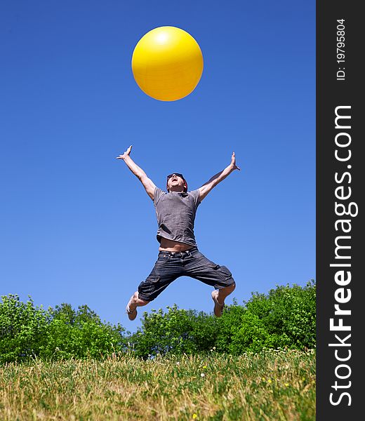 Young man jump in park with yellow ball. Young man jump in park with yellow ball