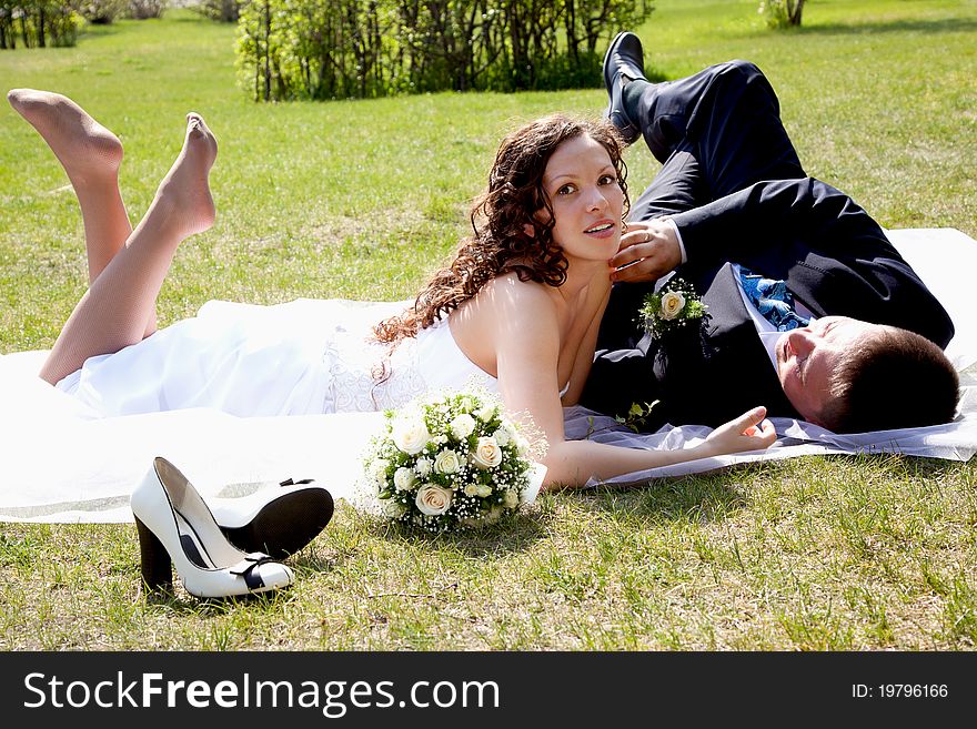 A couple on their wedding day kissing and laughing. A couple on their wedding day kissing and laughing