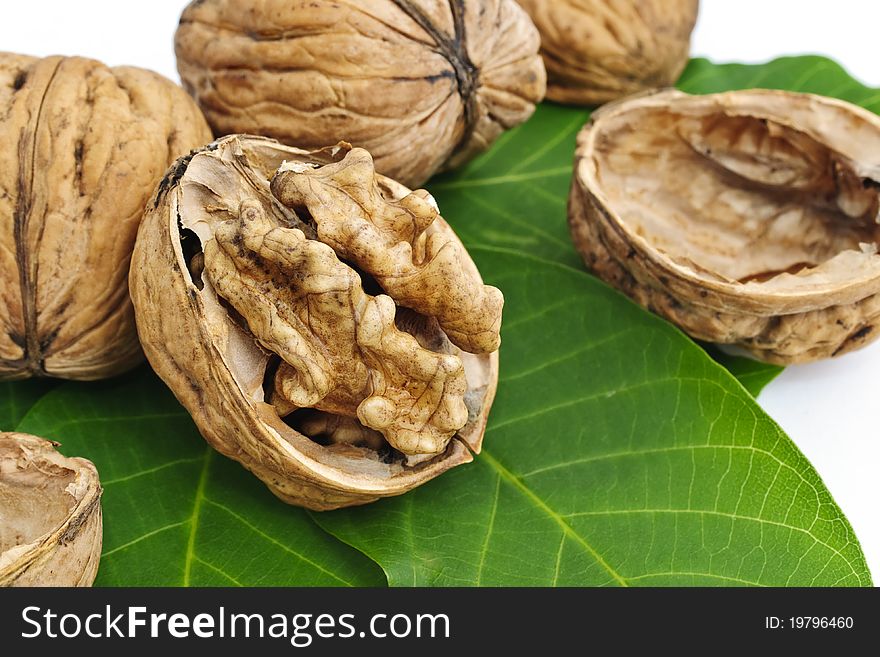 Whole and crushed walnuts with leaves. Whole and crushed walnuts with leaves