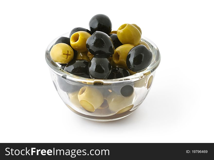 Green and black olives in a glass bowl isolated on white with clipping path