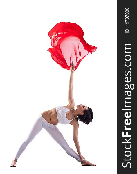 Woman doing yoga pose and red flying cloth in air