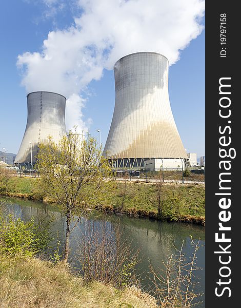 Smokestacks of nuclear factory and river in summer. Smokestacks of nuclear factory and river in summer