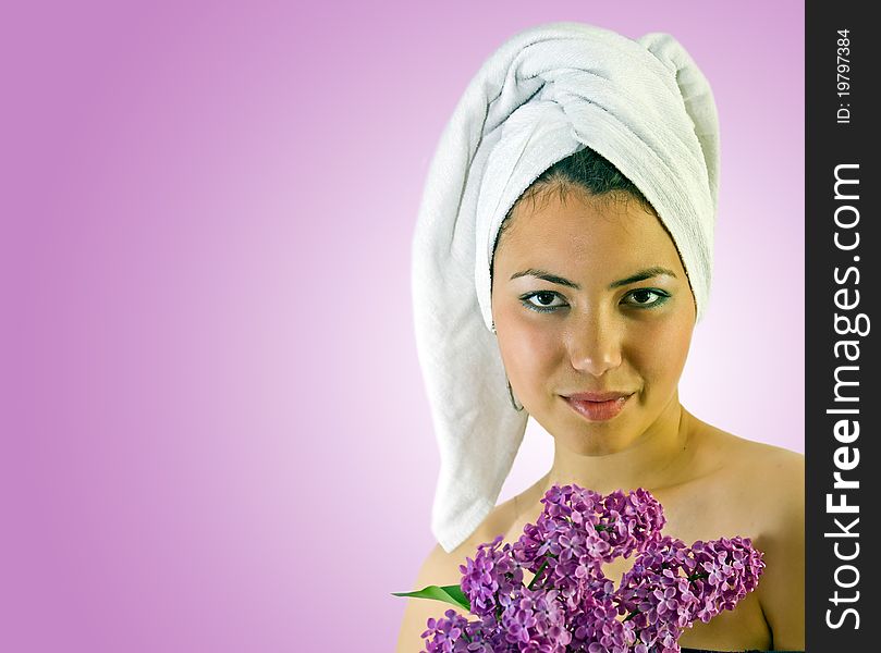 Attractive young girl with towel and lilac