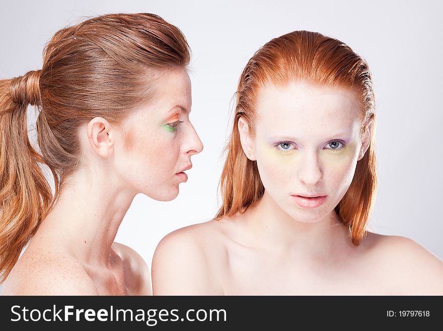 Two beautiful red-haired woman confront