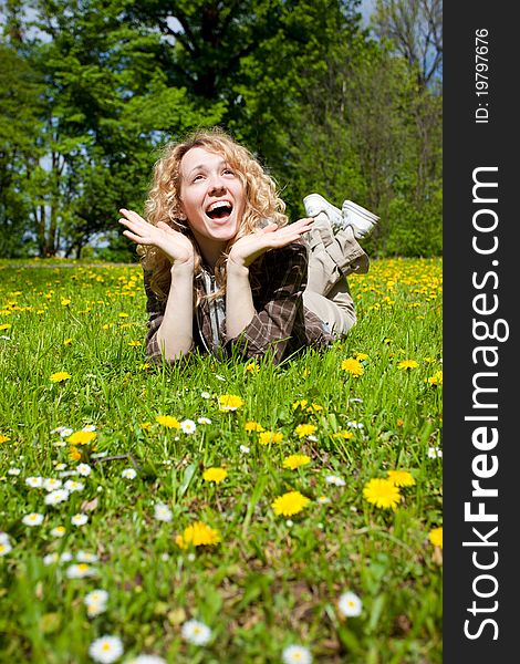 Happy surprised woman on flower field lookin up