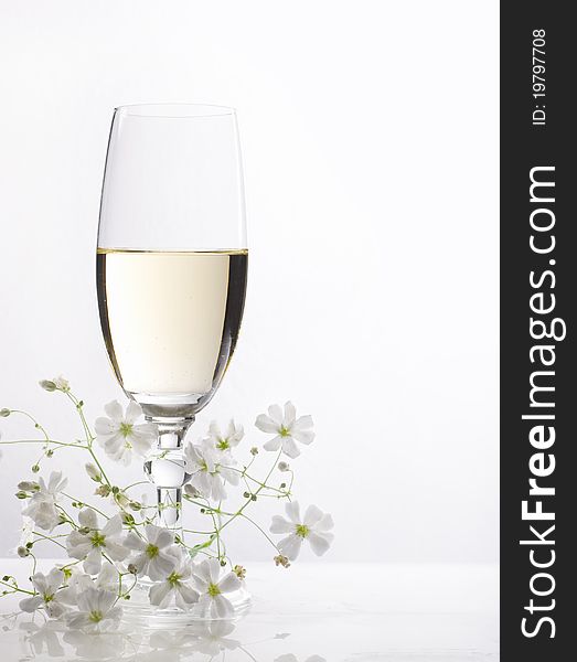 Glass of white wine and flowers