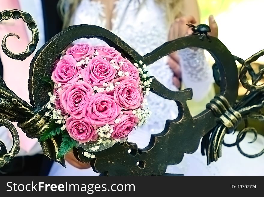 Bridal bouquet in the heart-shaped forged sculpture. Bridal bouquet in the heart-shaped forged sculpture