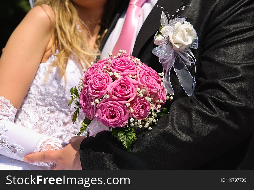 Bridal bouquet in the hands of bride and groom. Bridal bouquet in the hands of bride and groom