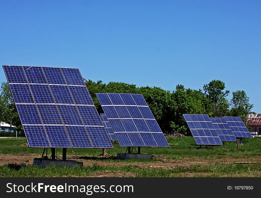A group of solar panels against blue sky