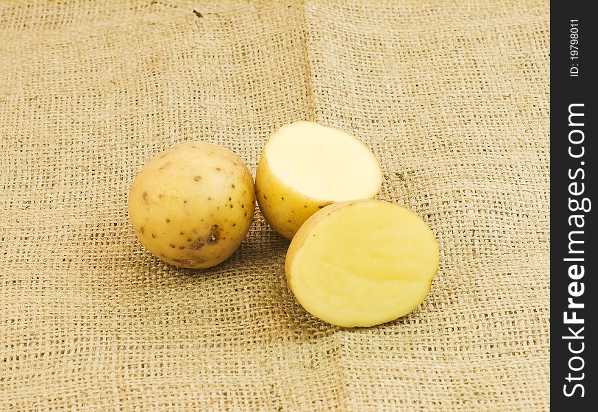 Sliced white potatoes in brown background