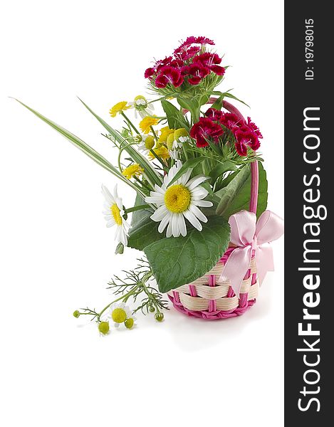 The wattled basket from a rod with natural flowers is isolated on a white background