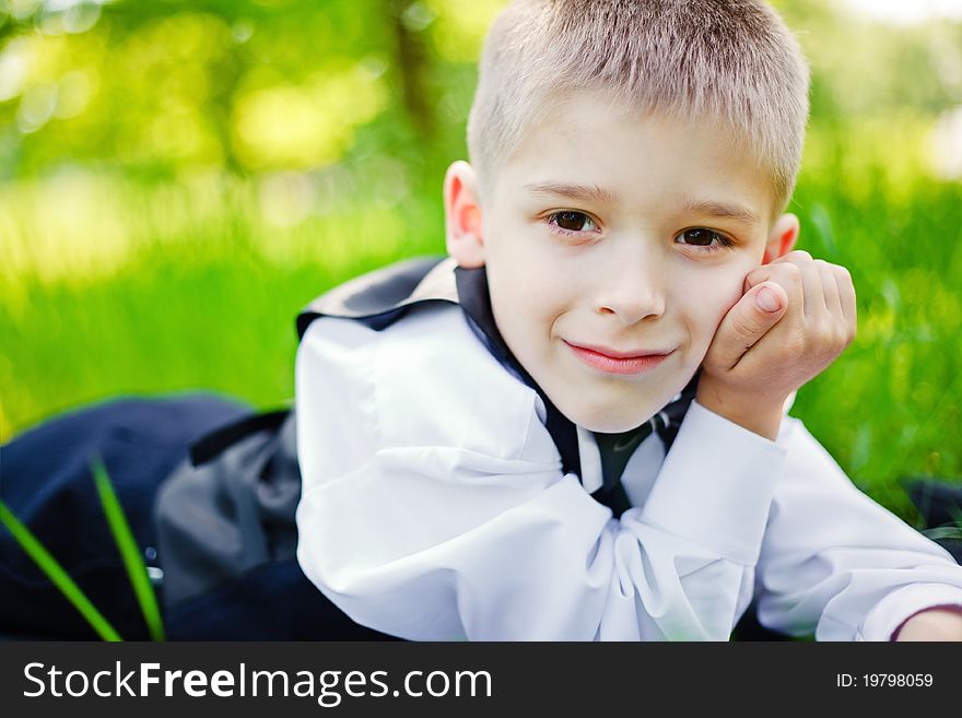 Little boy in a shirt and vest in park