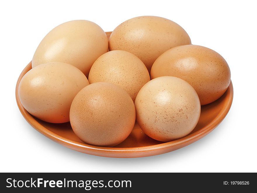 7 eggs of brown on a ceramic plate. 7 eggs of brown on a ceramic plate