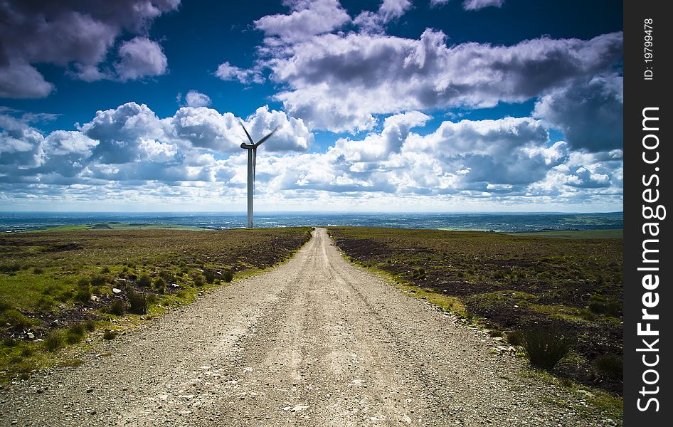 Long road with wind turbine in the distance. Long road with wind turbine in the distance.
