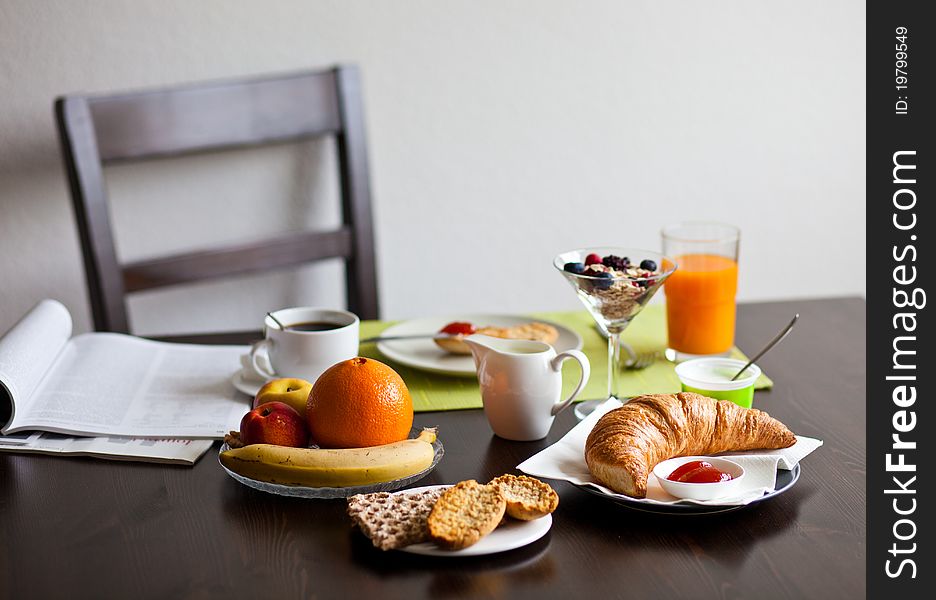 Delicious breakfast with croissant, jam, coffey, fruits and orange juice