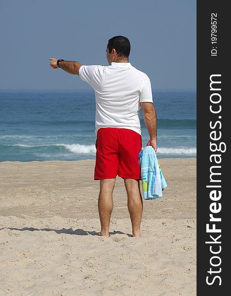 Men with pointing the sea on the beach. Men with pointing the sea on the beach