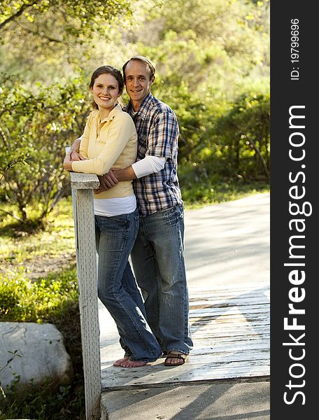 Caucasian Couple On Outdoor Wooden Bridge