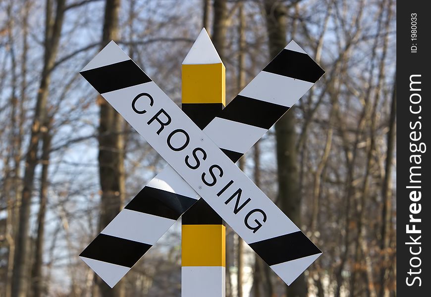Black and white and yellow crossing sign