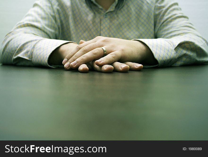 Male hands on a brown table waiting for a partner for discussion. Male hands on a brown table waiting for a partner for discussion