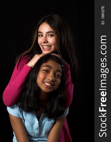 Teen posing over black backdrop