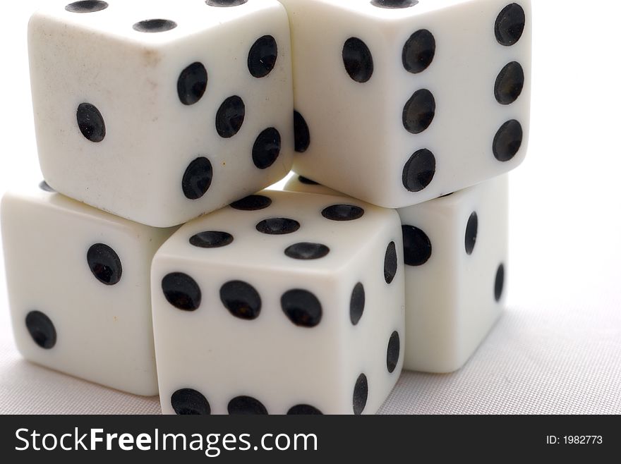 Five dices stacked up together in a whte background