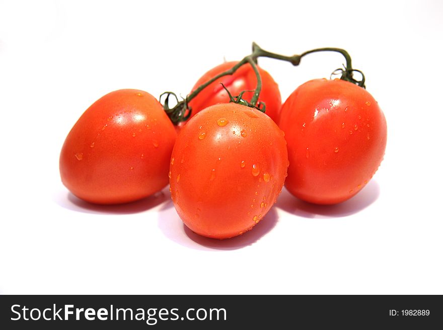 Organic tomatoes with water droplets on white background