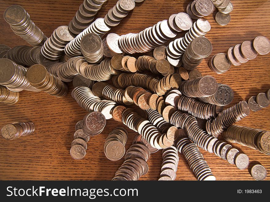 Set of coins in columns and  heaps on a table, (studio, halogen light). Set of coins in columns and  heaps on a table, (studio, halogen light).