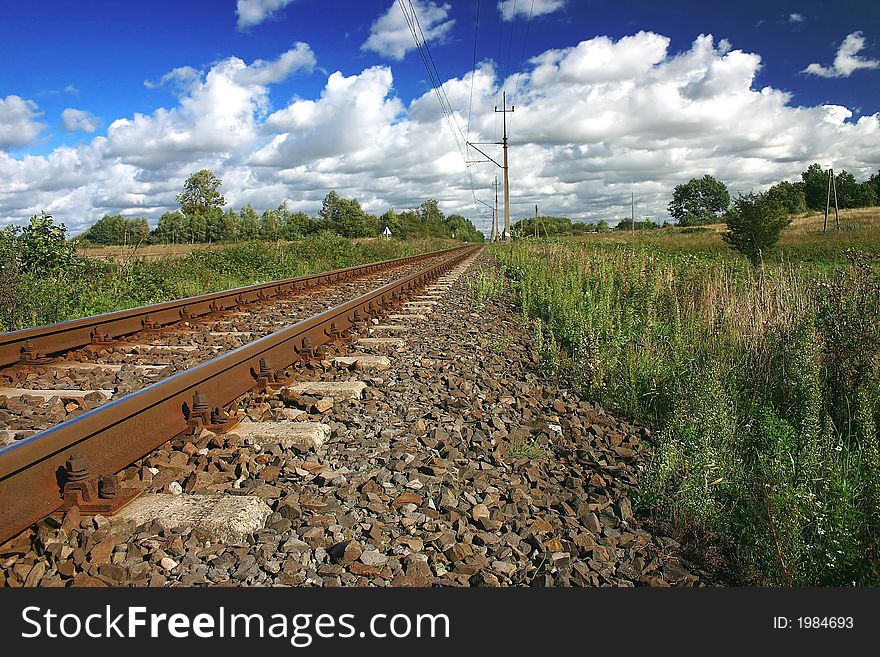 Railway on sunny day with beautiful clouds background.