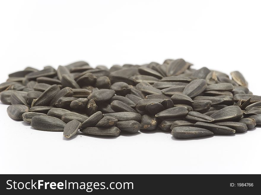 Black raw sunflower seeds isolated on white