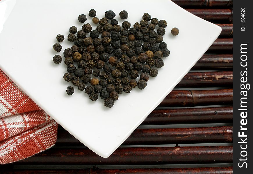 Black peppercorn on a square plate