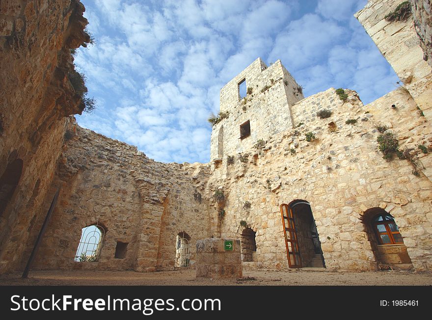 Wide angle view inside old castle with arrow points to the exit. Wide angle view inside old castle with arrow points to the exit