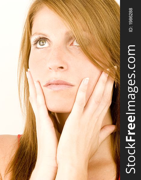 A young woman deep in thought against a plain background.