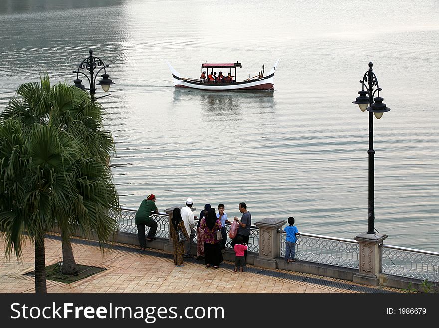 A Malaysian traditional boat cruises on a lake in Putrajaya.
