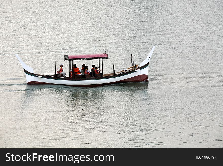 A Malaysian traditional boat cruises on a lake in Putrajaya.