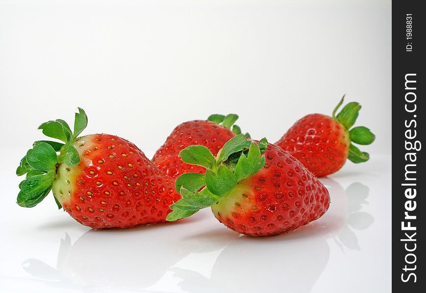 Strawberries on a gleamy surface