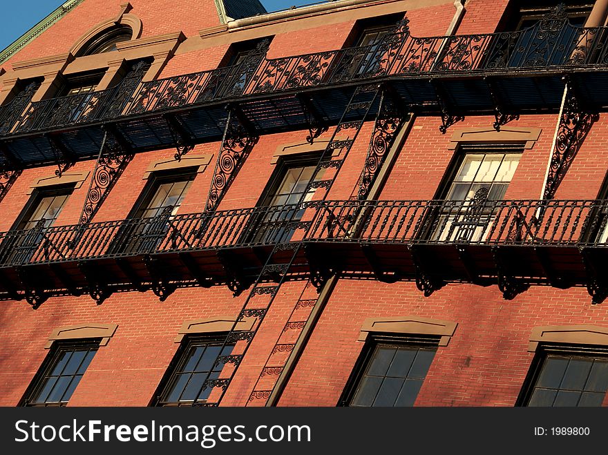 Sunset casts a soft orange light on older brick building in boston. Sunset casts a soft orange light on older brick building in boston