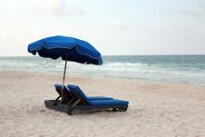 Umbrella Shaded Beach Lounge Chairs Stock Photo