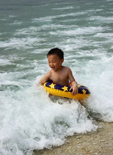 An Asian Boy In Wave Stock Photos