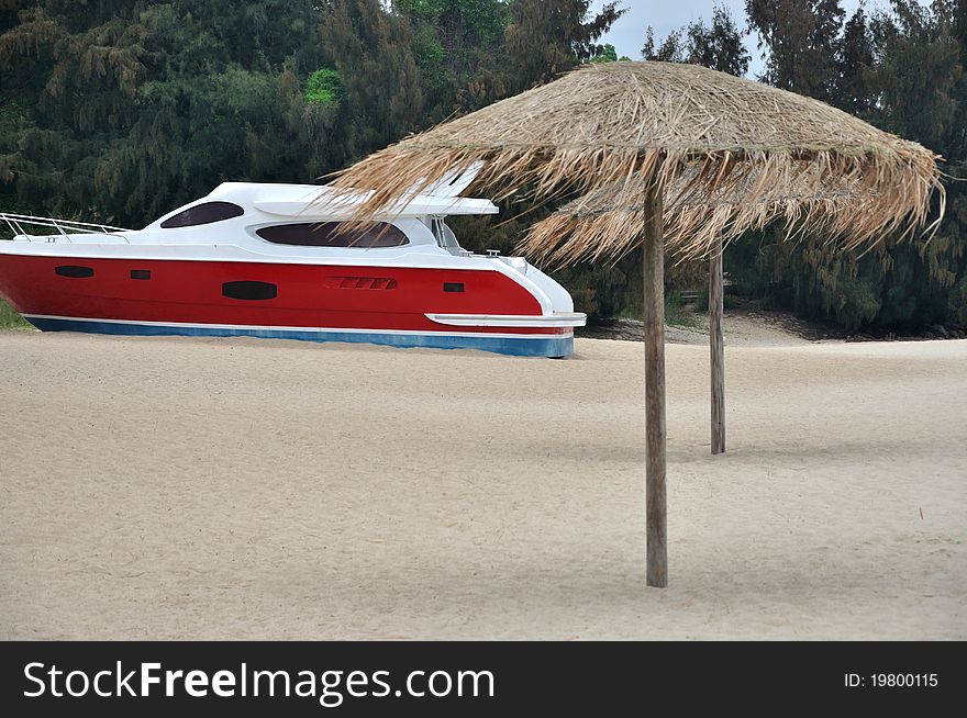 A small red yacht on beach sand, shown as enjoy holidy, marine sport recreation and view of sea beach. A small red yacht on beach sand, shown as enjoy holidy, marine sport recreation and view of sea beach.