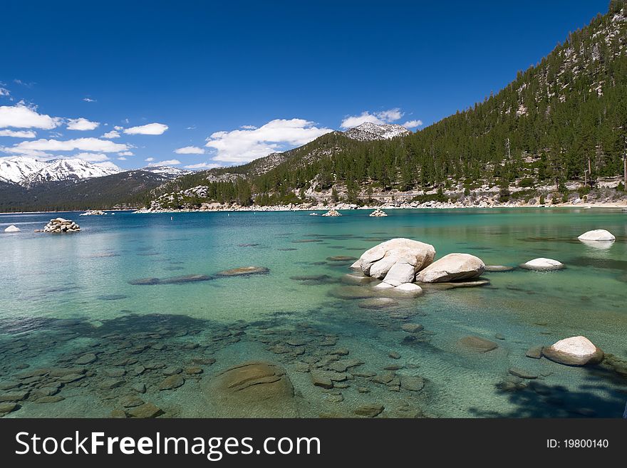 Lake Tahoe shallow water with few clouds on sky