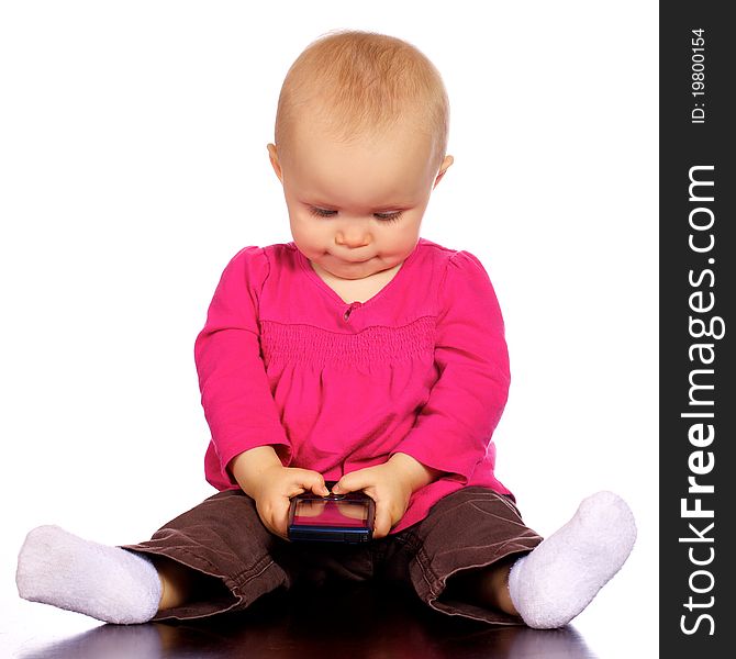 Infant girl playing with a cell phone