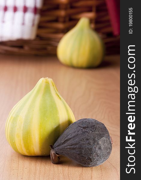 Ripe fruits of a fig on a wooden table.