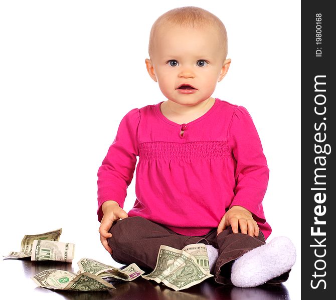 Infant baby girl playing with money